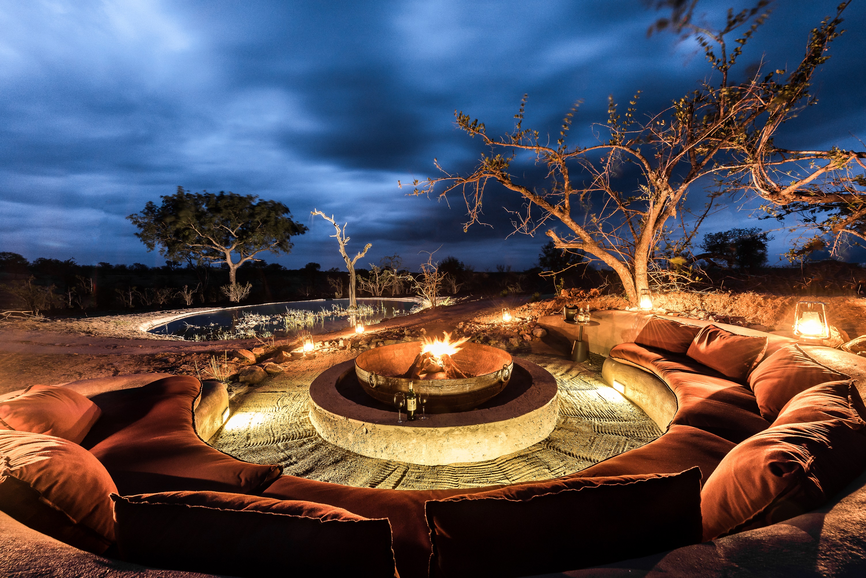 <p>The Sabi Sabi Earth Lodge features a beautiful fire pit area, which is a popular spot for guests to relax and unwind after a long day of safari activities. The fire pit is located in a secluded area of the lodge's property, surrounded by trees and bush, providing a peaceful and tranquil setting.</p>